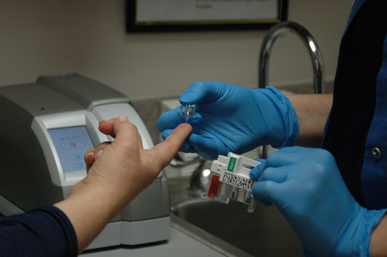 Nurse testing a diabetes patient's blood sugar level Nurse testing a diabetes patient's blood sugar level