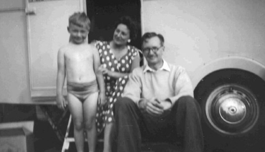 A black and white photo of Paul Workman as a young boy with his parents