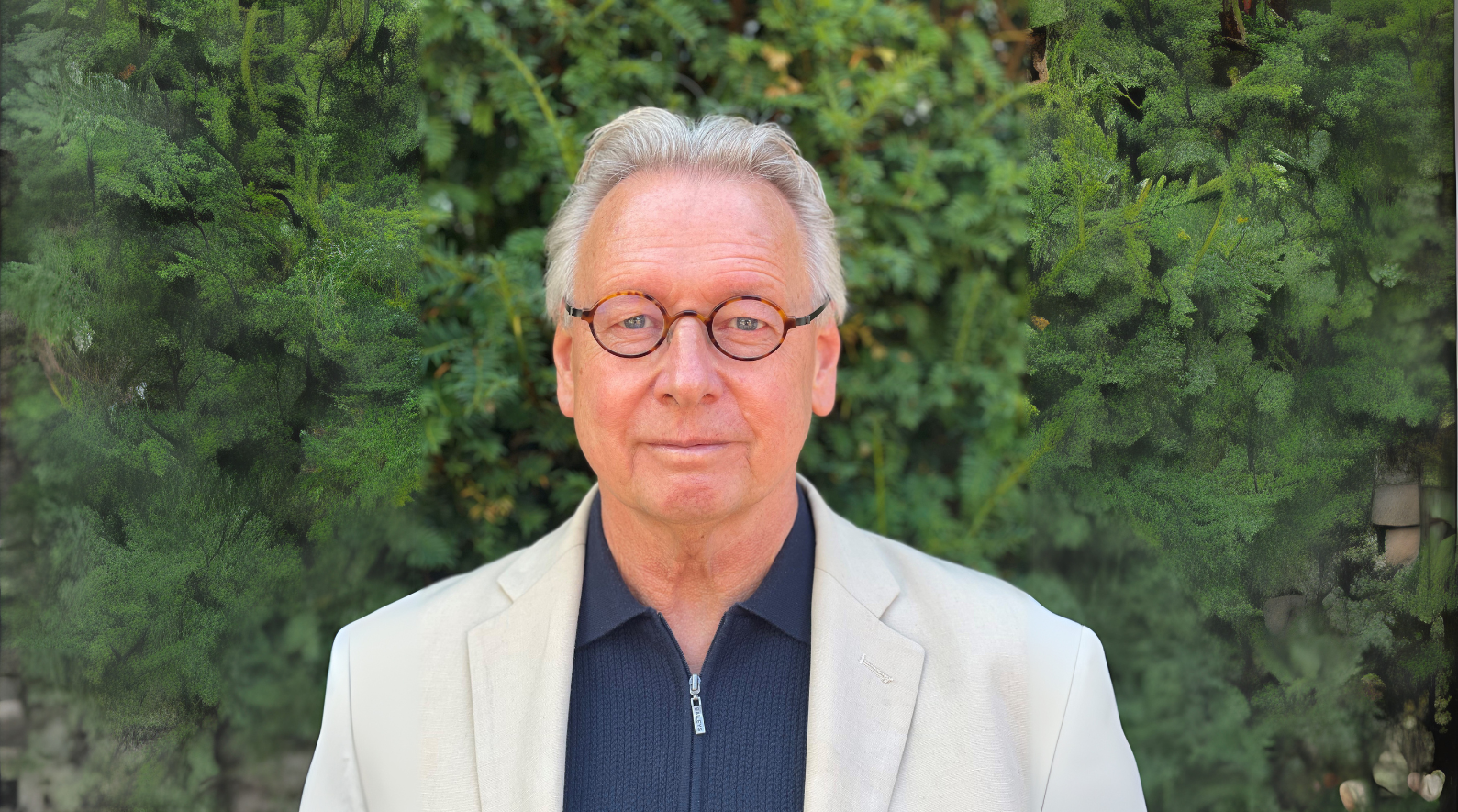 A picture of Professor Paul Workman standing in a garden