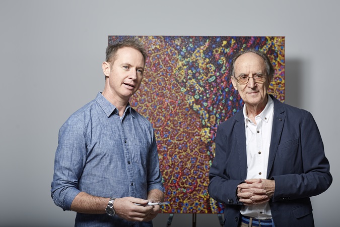 Philanthropy - pipette art - two men stand in front of a painting of lots of colourful dots