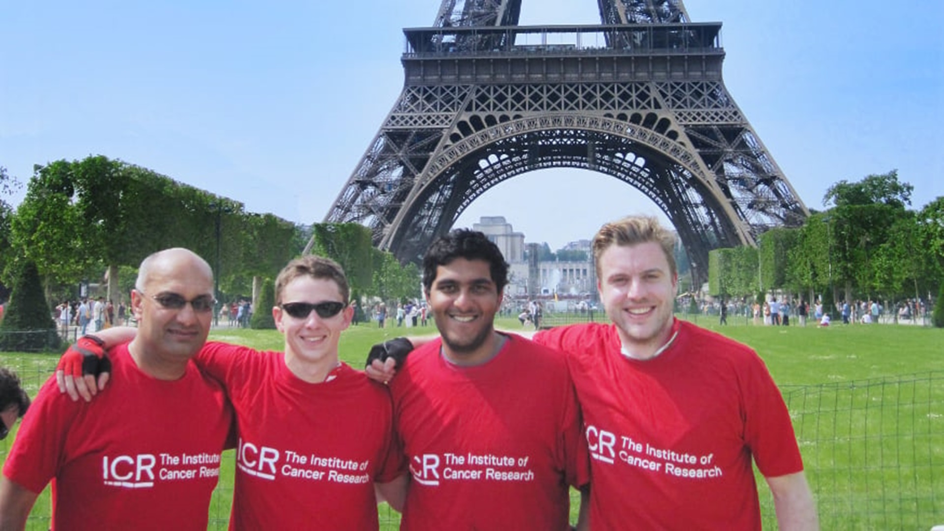 Riders enjoying finishing the London to Paris Cycle Ride underneath the Eiffel Tower