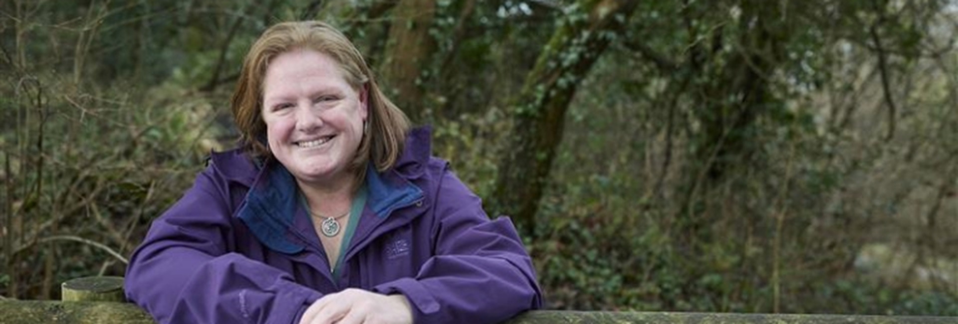 Cecelia smiling in a woodland background