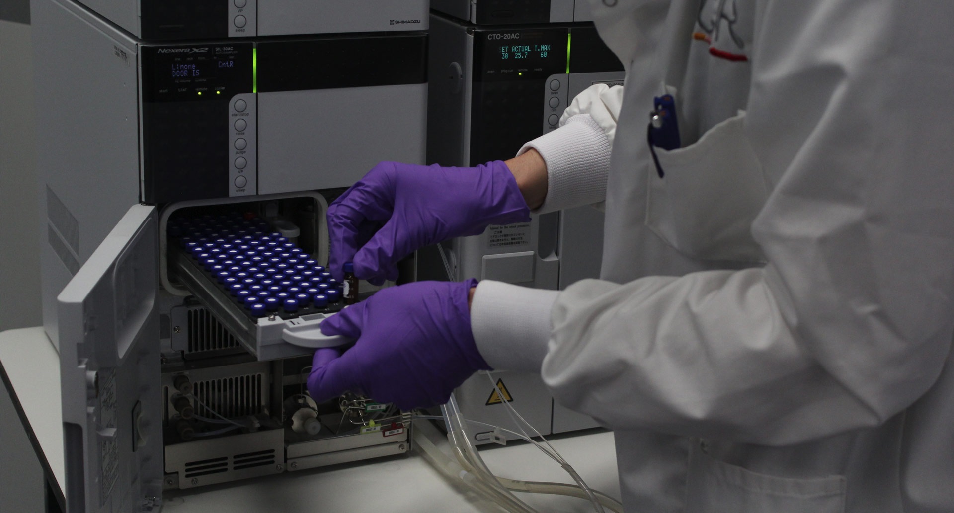 Researcher placing a sample into a proteomics device