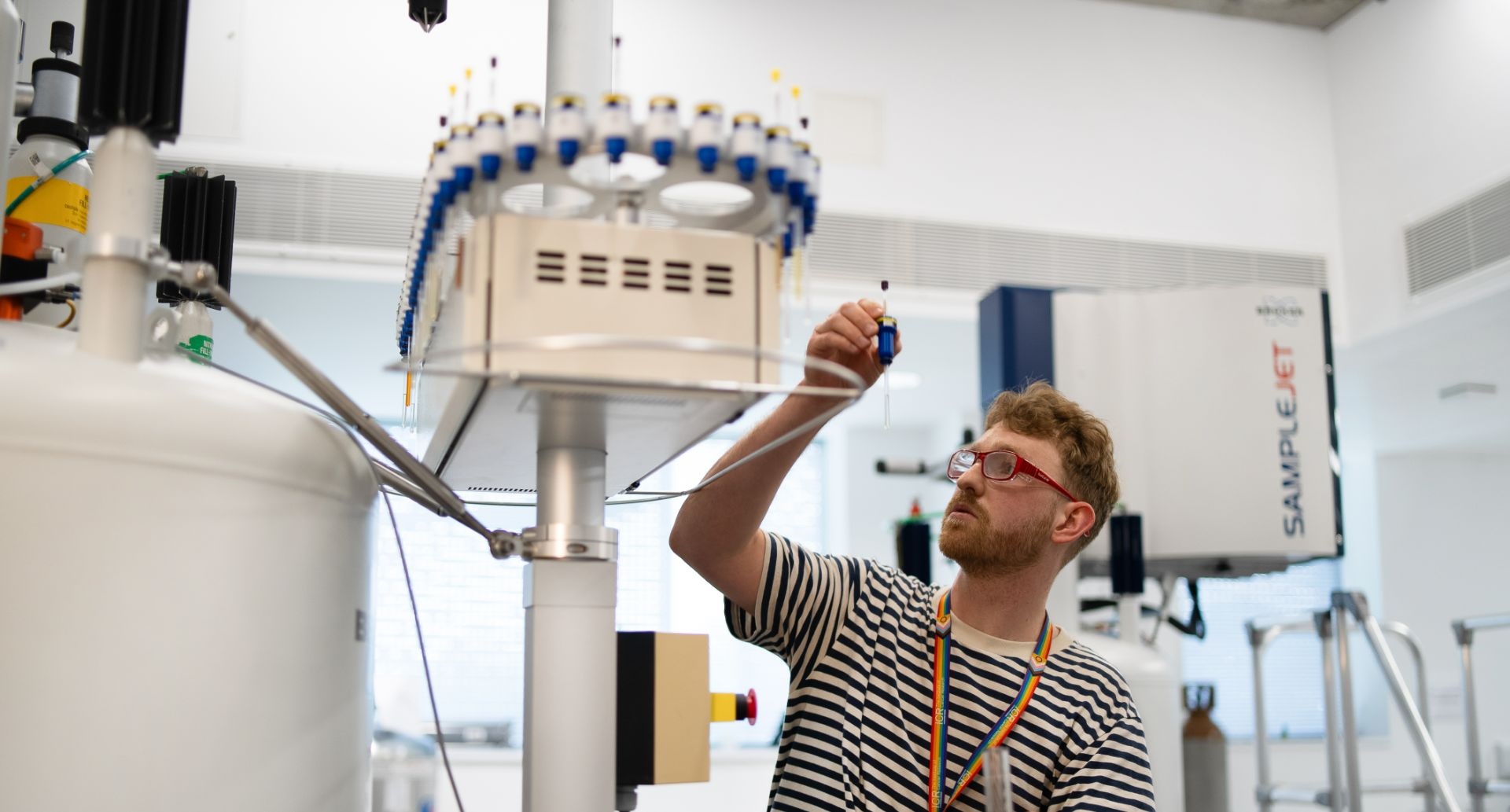 Scientist working on NMR machine in lab