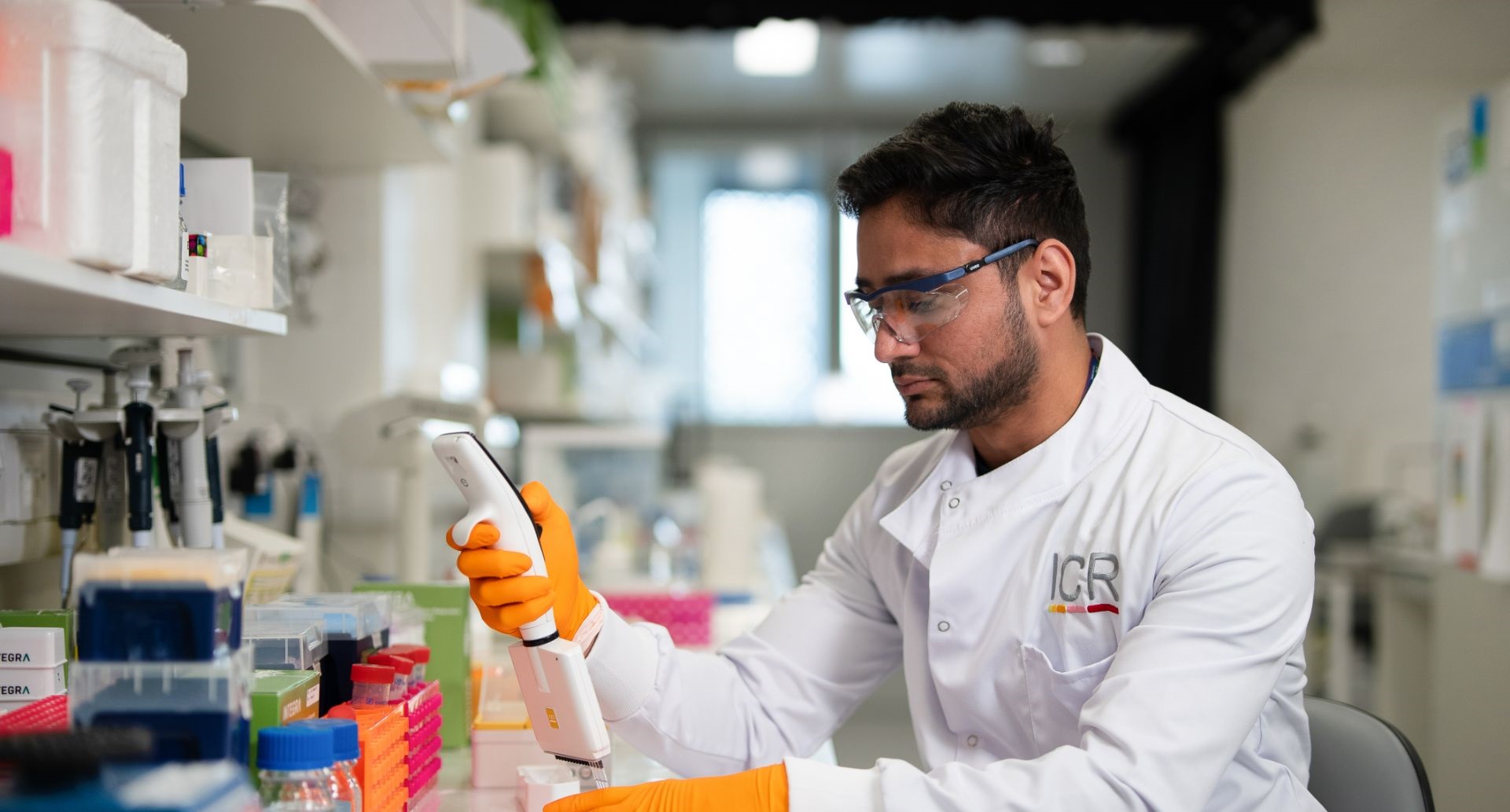 Scientist using multichannel pipette with goggles on