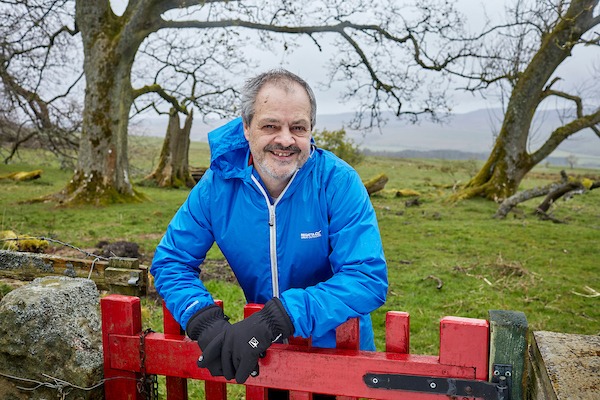 Michael parry standing behind a red gate