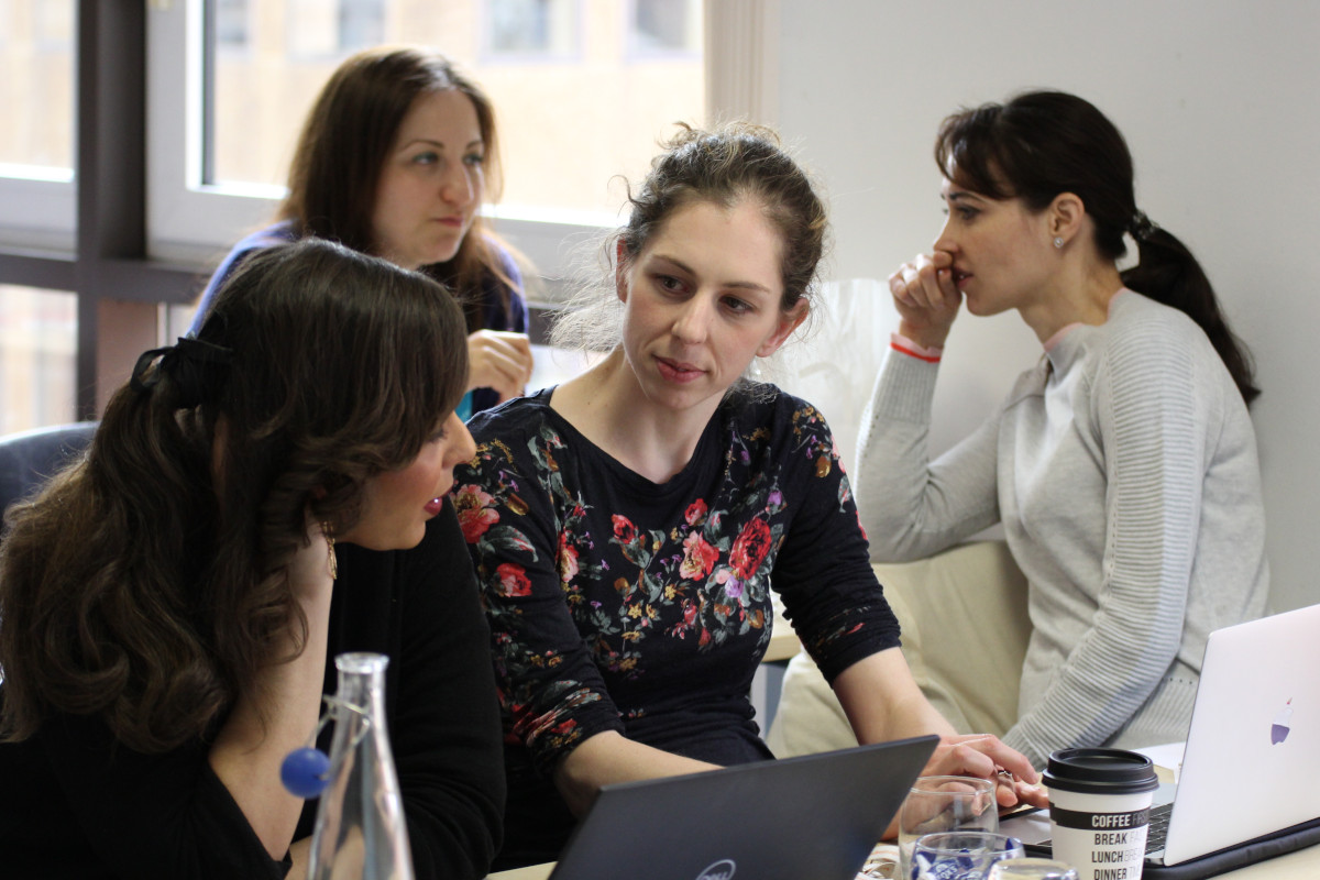 Students having a discussion at a computer