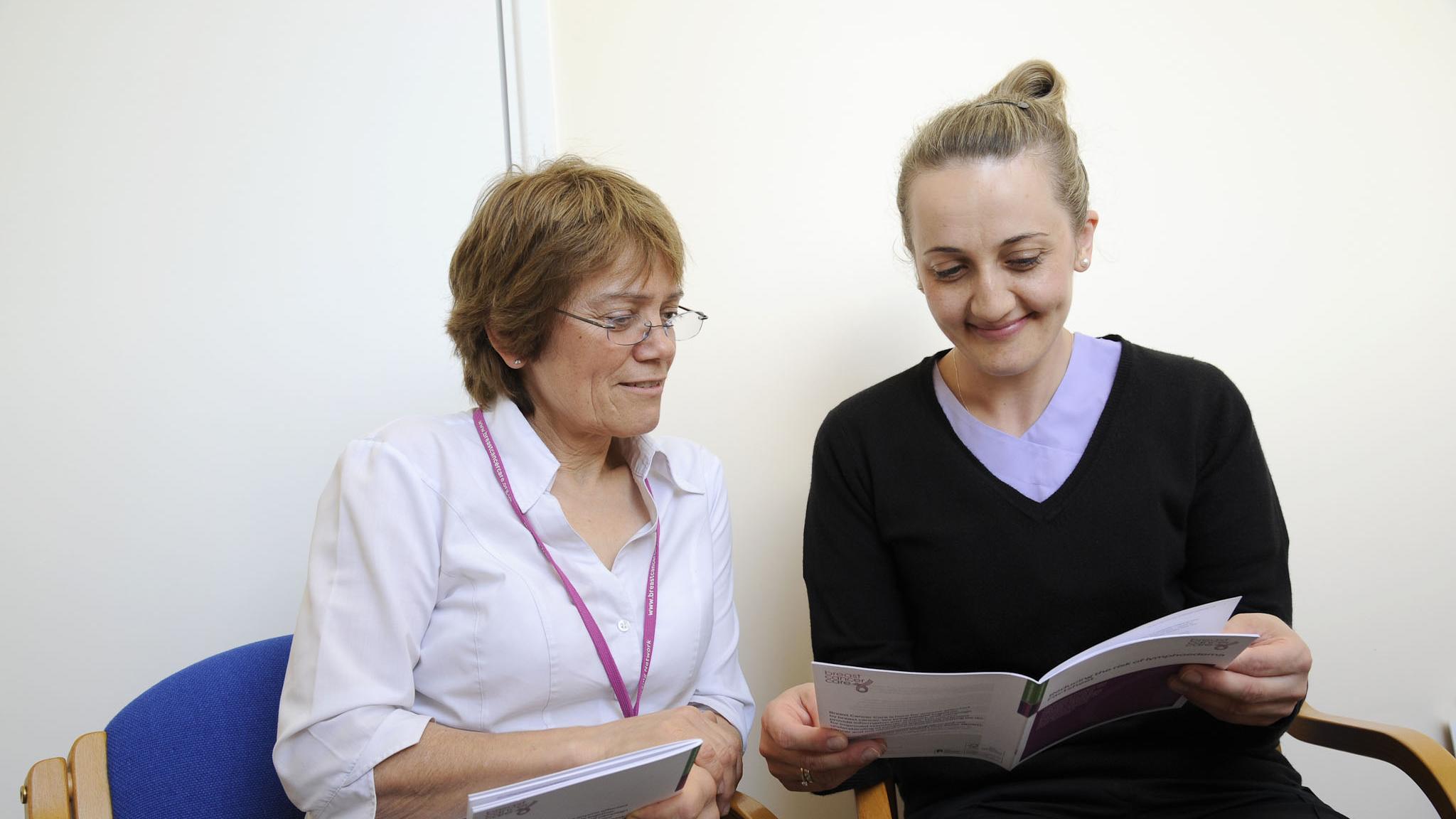 Two researchers looking at a guidance doc