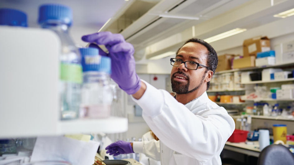 Michael Ranes in the lab wearing a lab coat