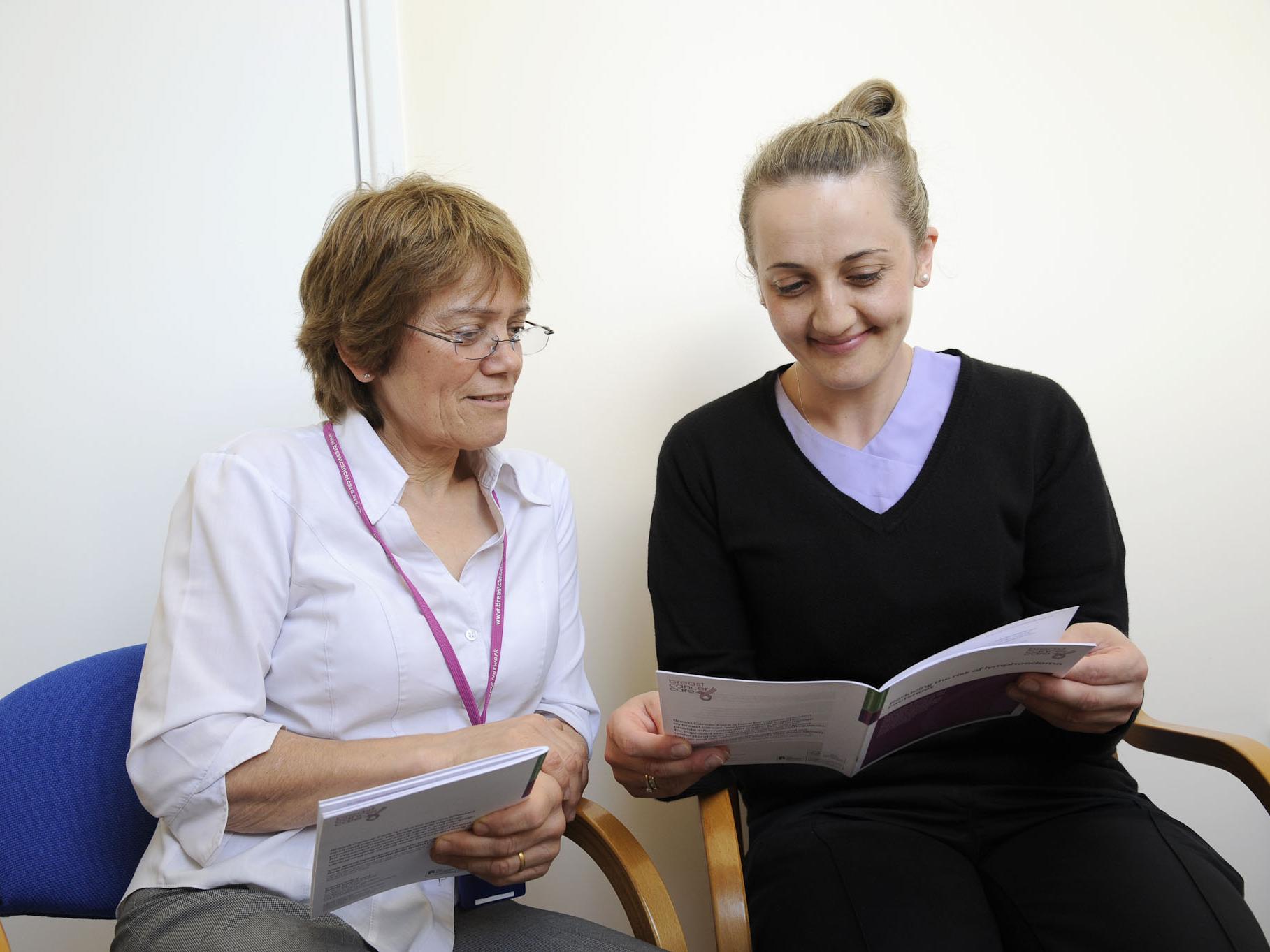 Two researchers looking at a guidance doc