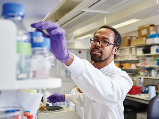 Dr Michael Ranes in the lab wearing a lab coat