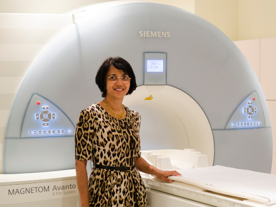 Nandita deSouza standing in front of a scanner