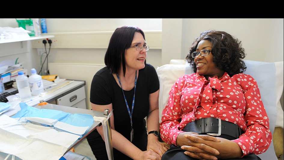 Nurse and patient on bed