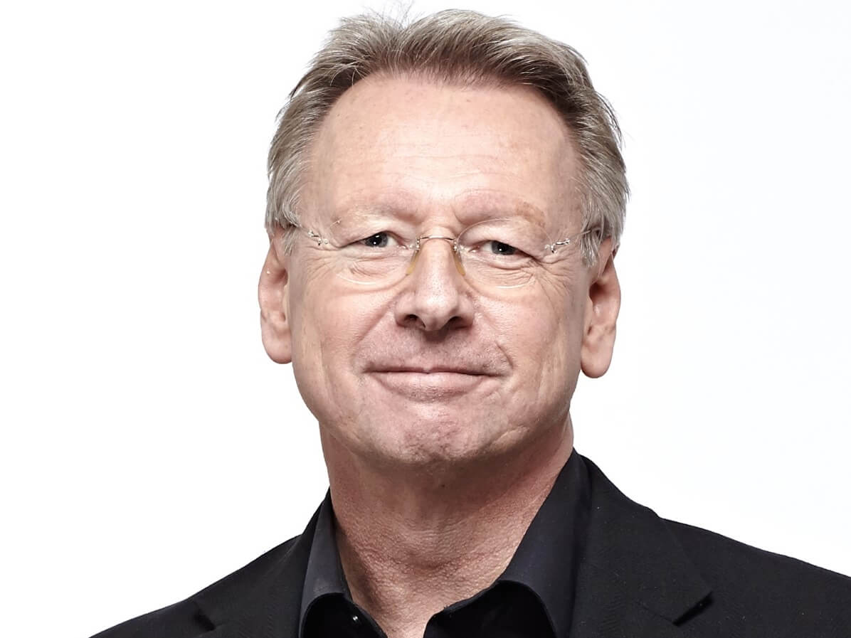 Shoulder-up profile image of Professor Paul Workman in a black suit and black shirt