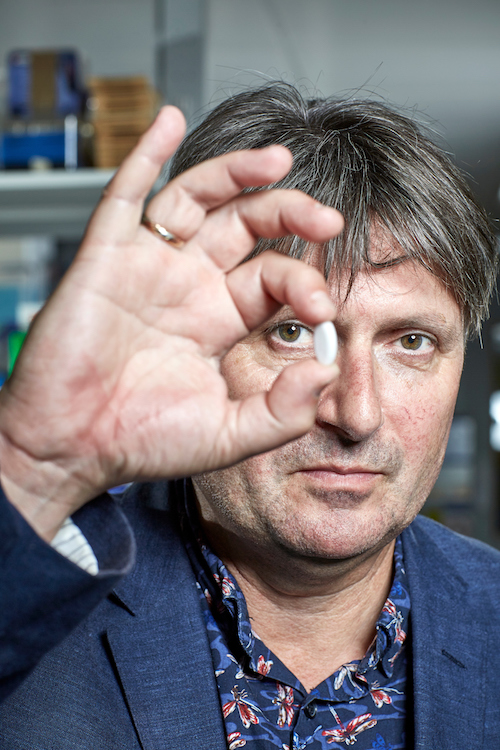 Poet Laureate Simon Armitage holding pill with poem - portrait - 500x750 Poet Laureate Simon Armitage holding pill with engraved poem