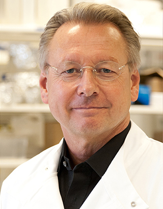 Professor Paul Workman in lab coat