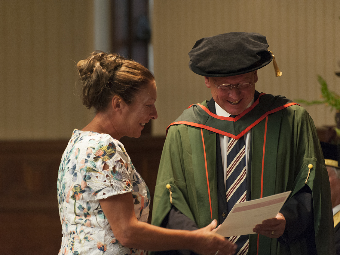 Professor Paul Workman presenting a graduation certificate