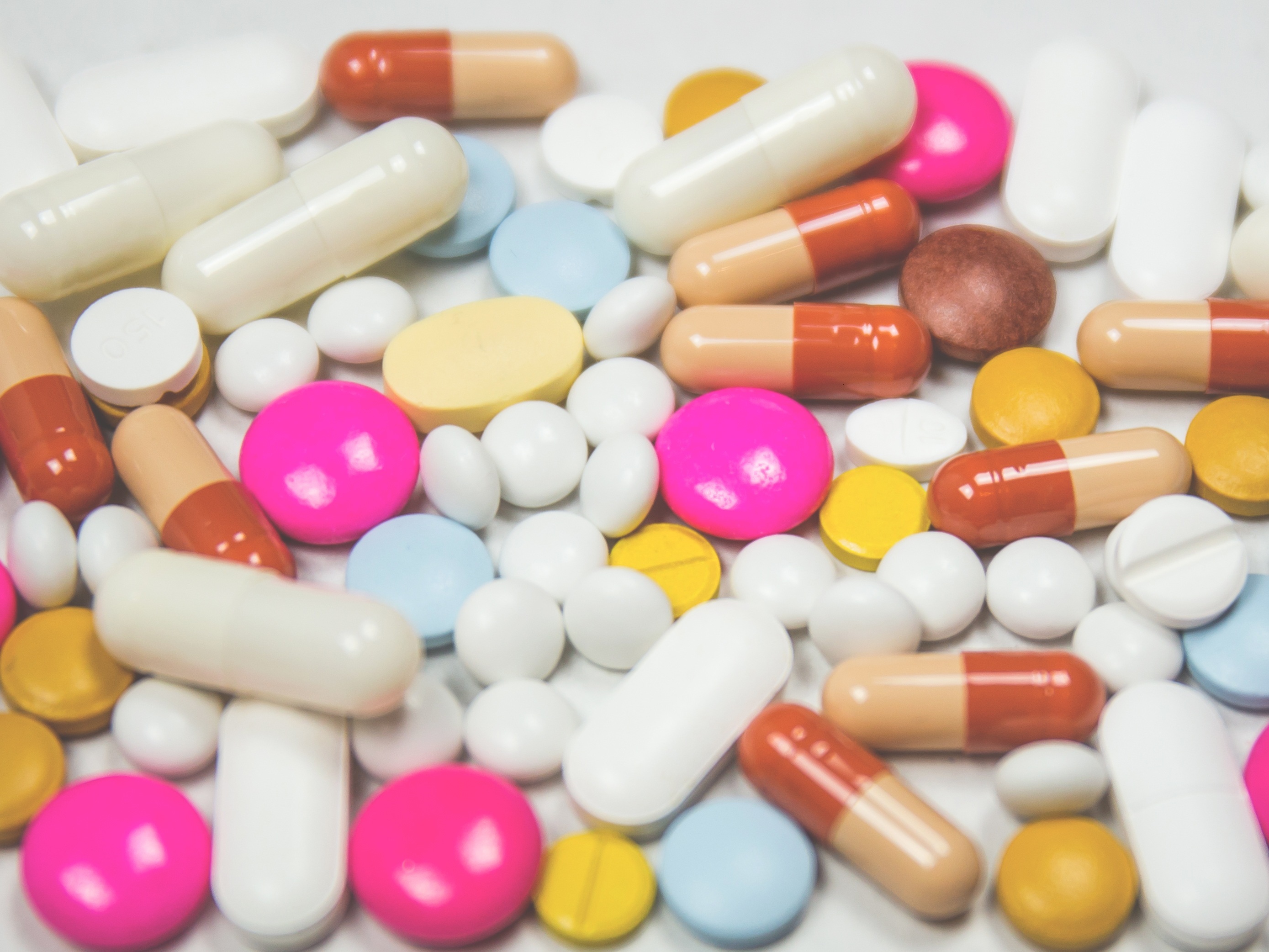 Assortment of multicoloured pills in a pile