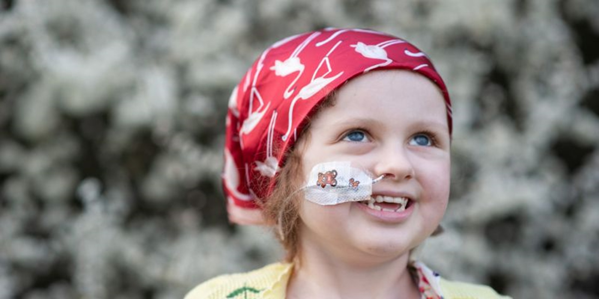 Portrait of Siobhan with nasal cannula, wearing a red headscarf