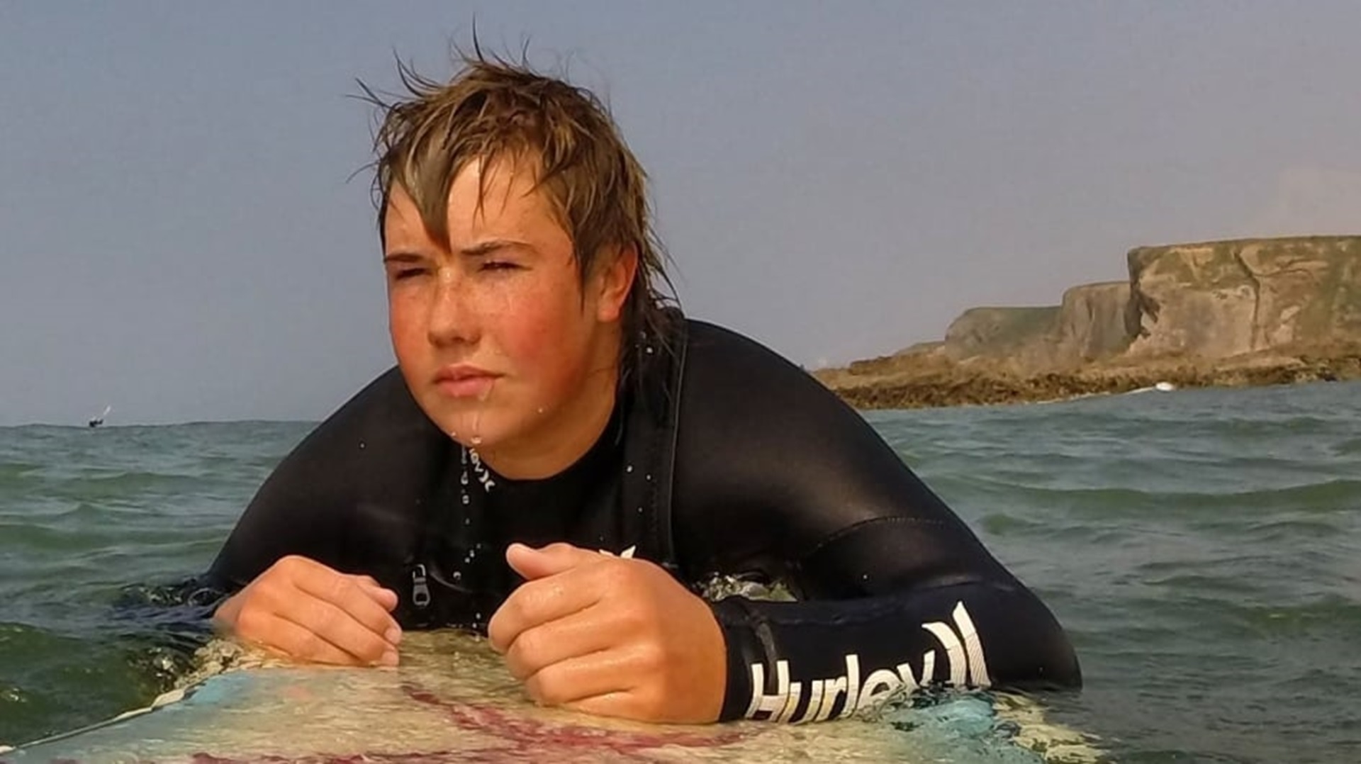 Talan Penny on a surfboard in the sea