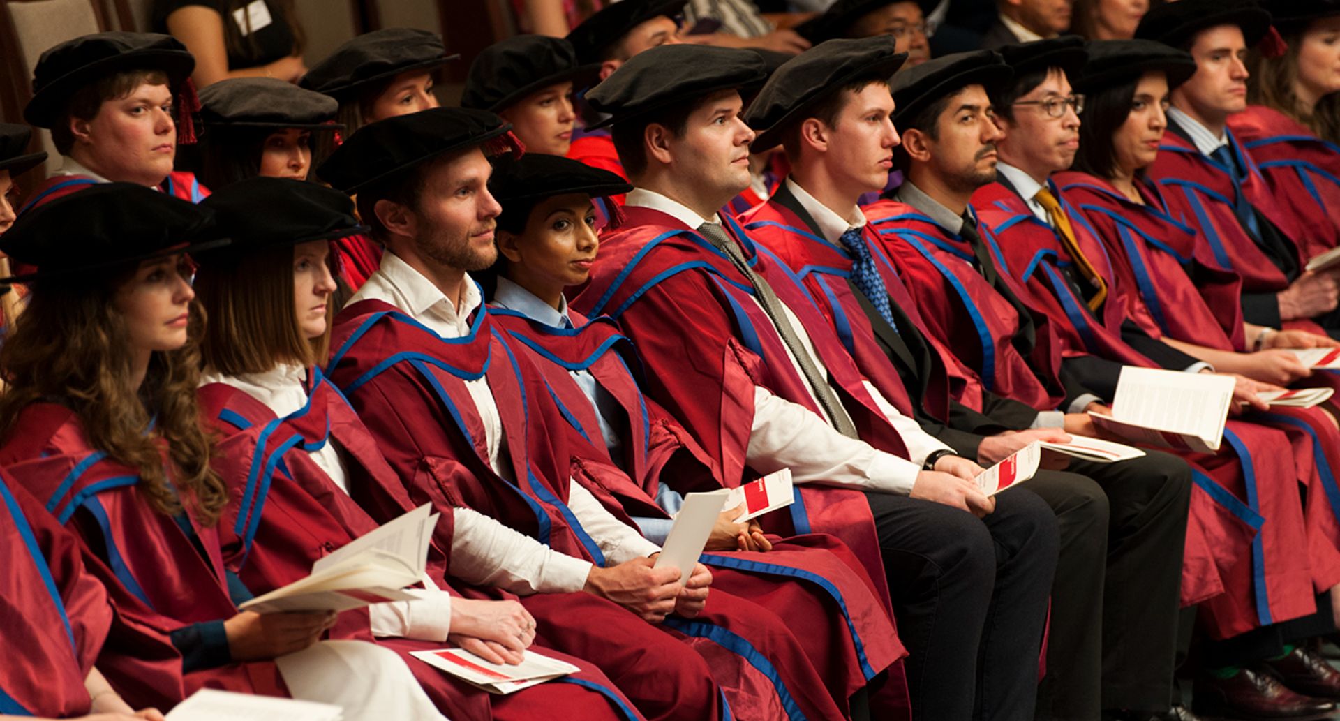 Gowned students sat in a line at graduation